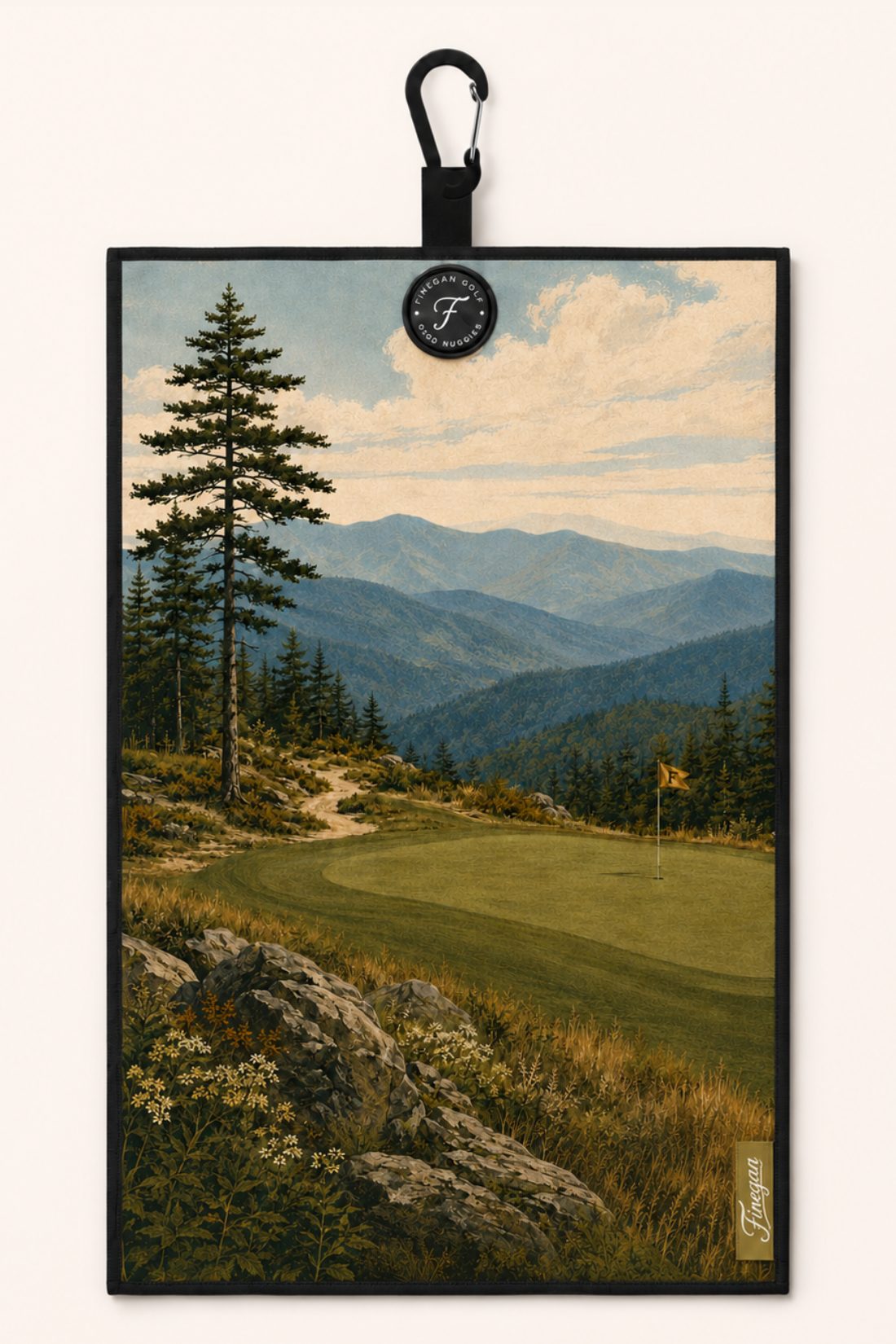 The Blue Ridge towel — a painted summit green above hazy mountain ridges, printed edge to edge, with carabiner clip and Finegan Golf badge